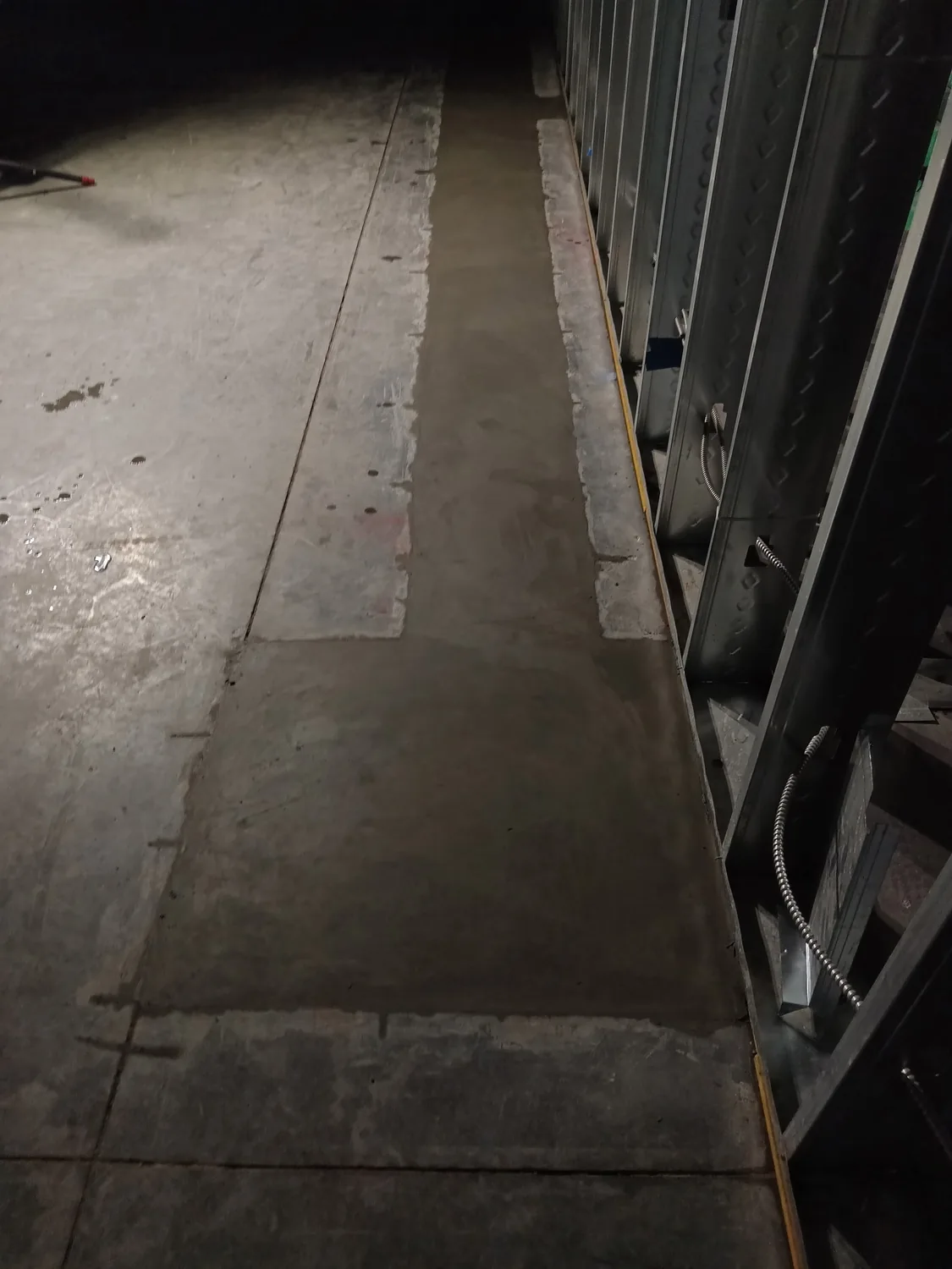 Night commercial concrete and utility trenching work under lights by Billy's Concrete
